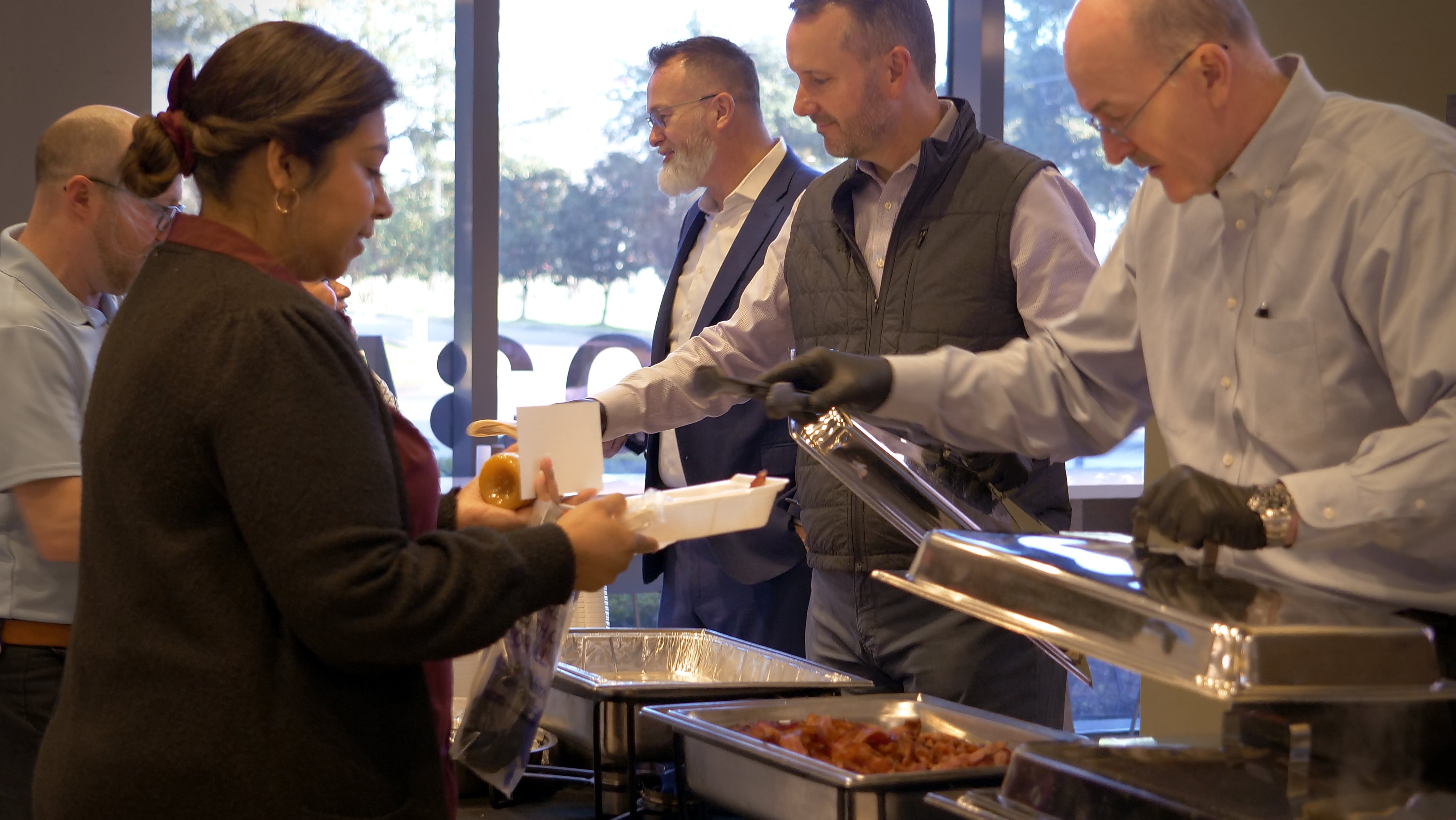 NOV employees serving food from catering trays