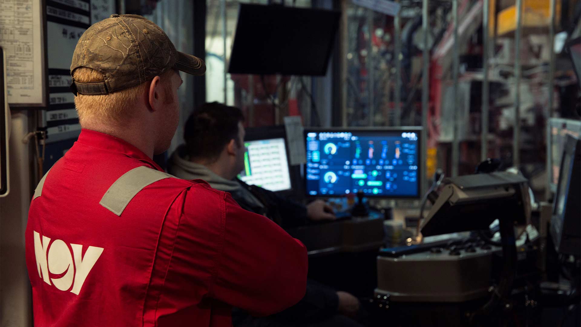 NOV employees look at a NOVOS system on a rig