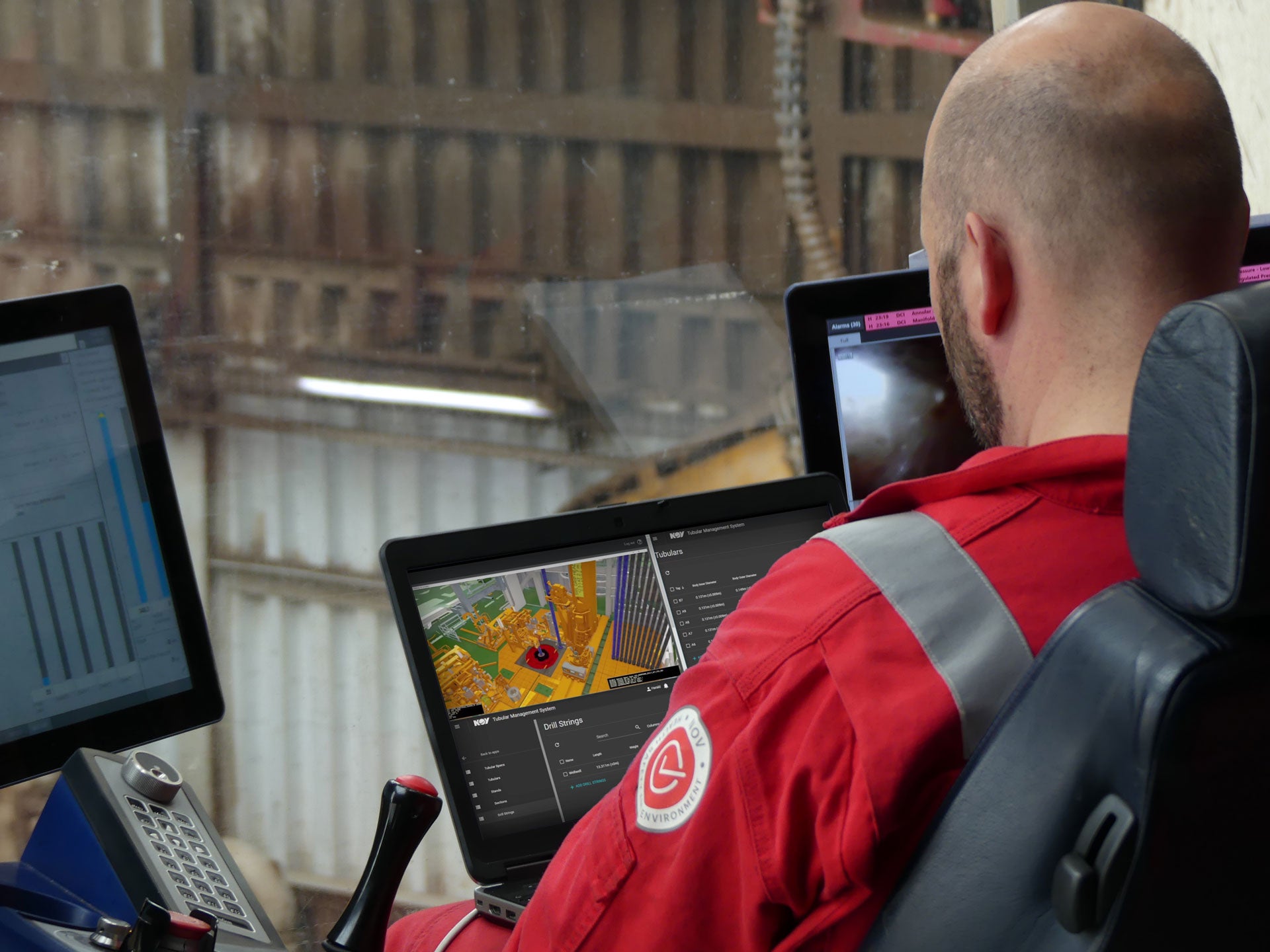 Drilling rig operator looking at Tally Master tubular tracking software program on a computer monitor from the drilling console