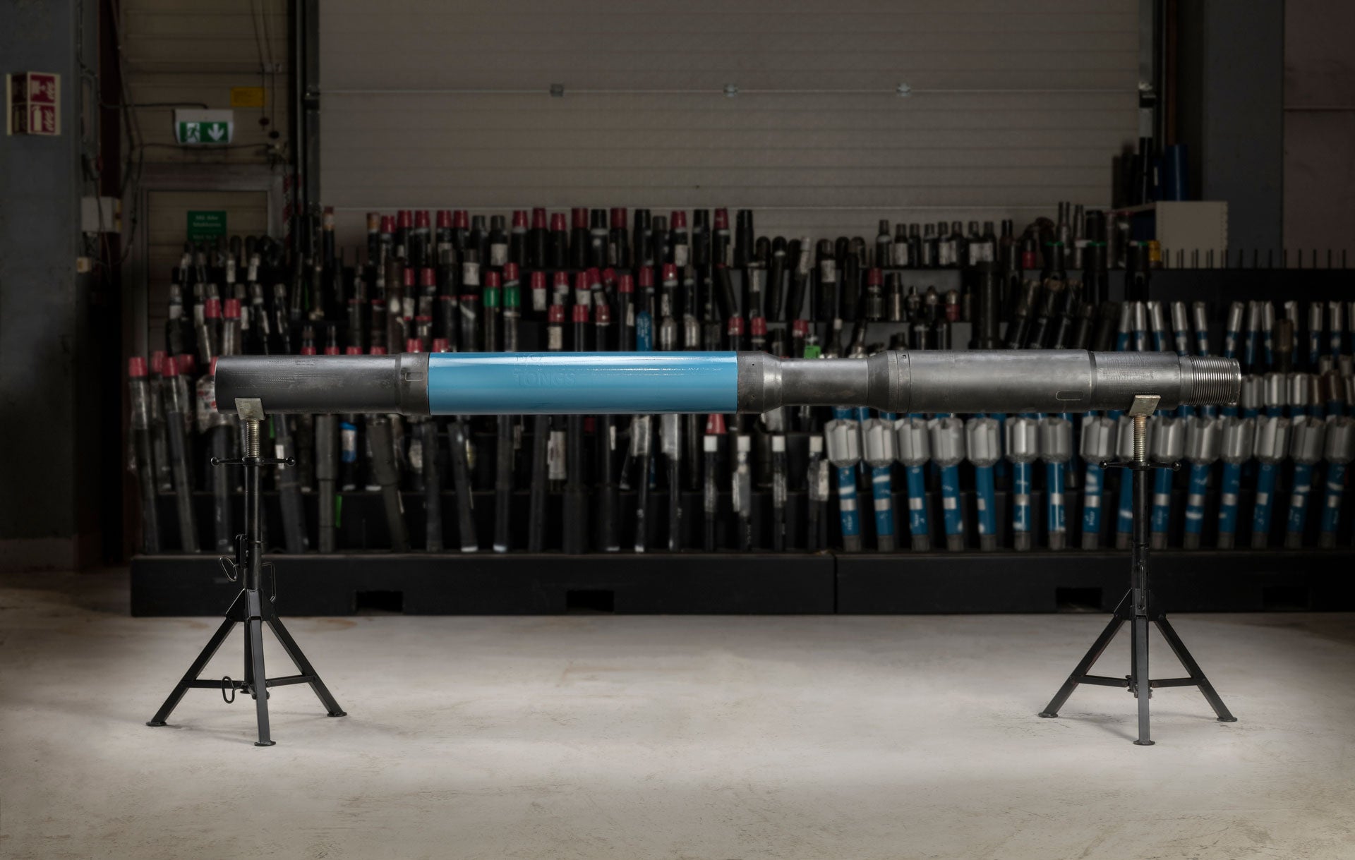 Side view of an i-Con Monitoring Sub on stands with equipment behind it