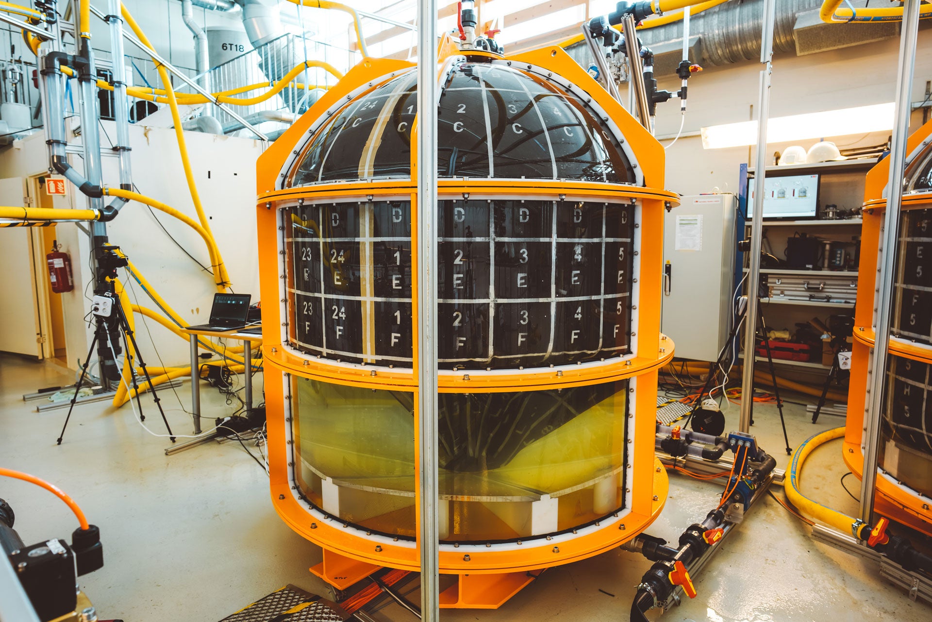 Stand alone picture of a yellow and black subsea storage unit in a facility