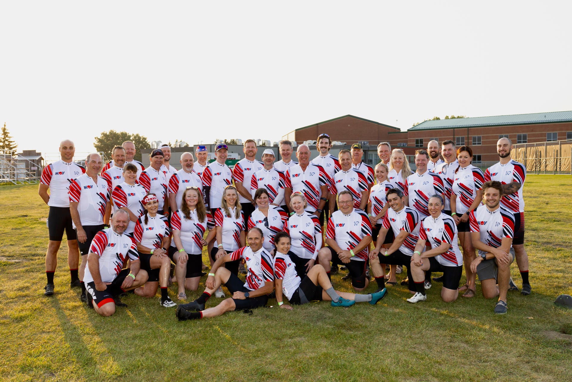 Group photo of the 2024 Tour Alberta for Cancer team on a field