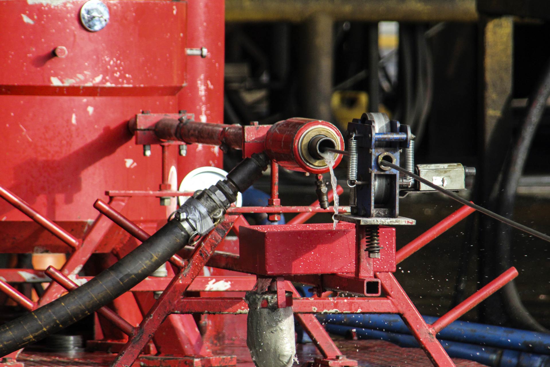 A tube connected to a machine unit dispenses liquid into a trough