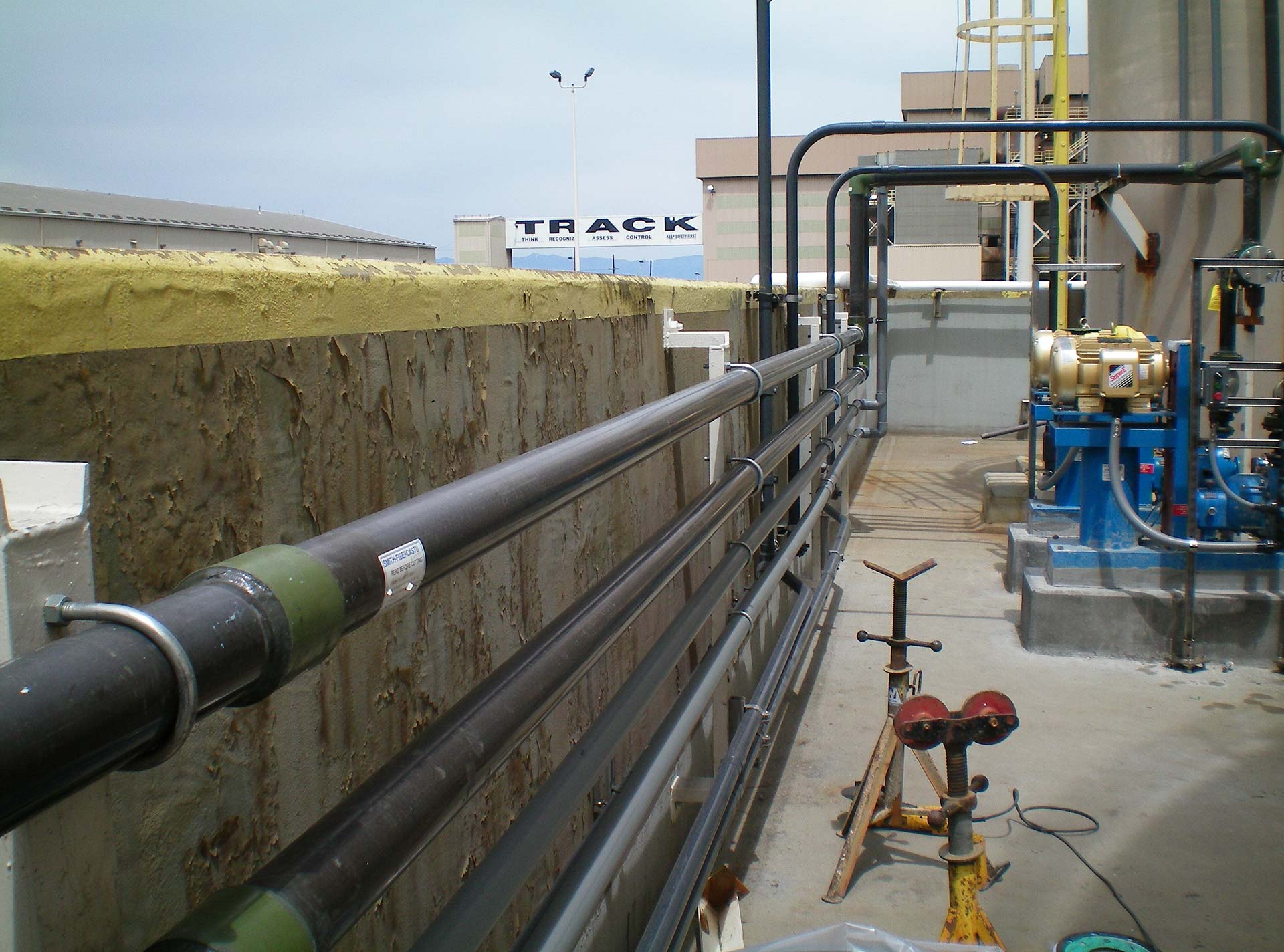 Several Z-Core Fiberglass Pipes line a concrete wall