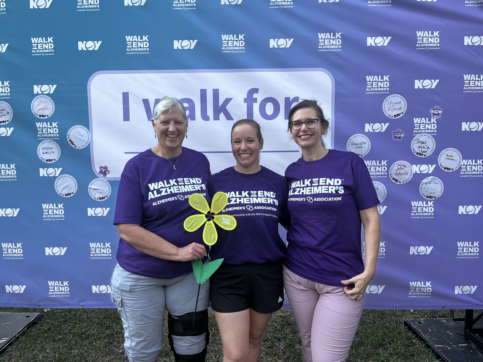 Group photo at the 2024 Walk to End Alzheimers event in front of a step and repeat