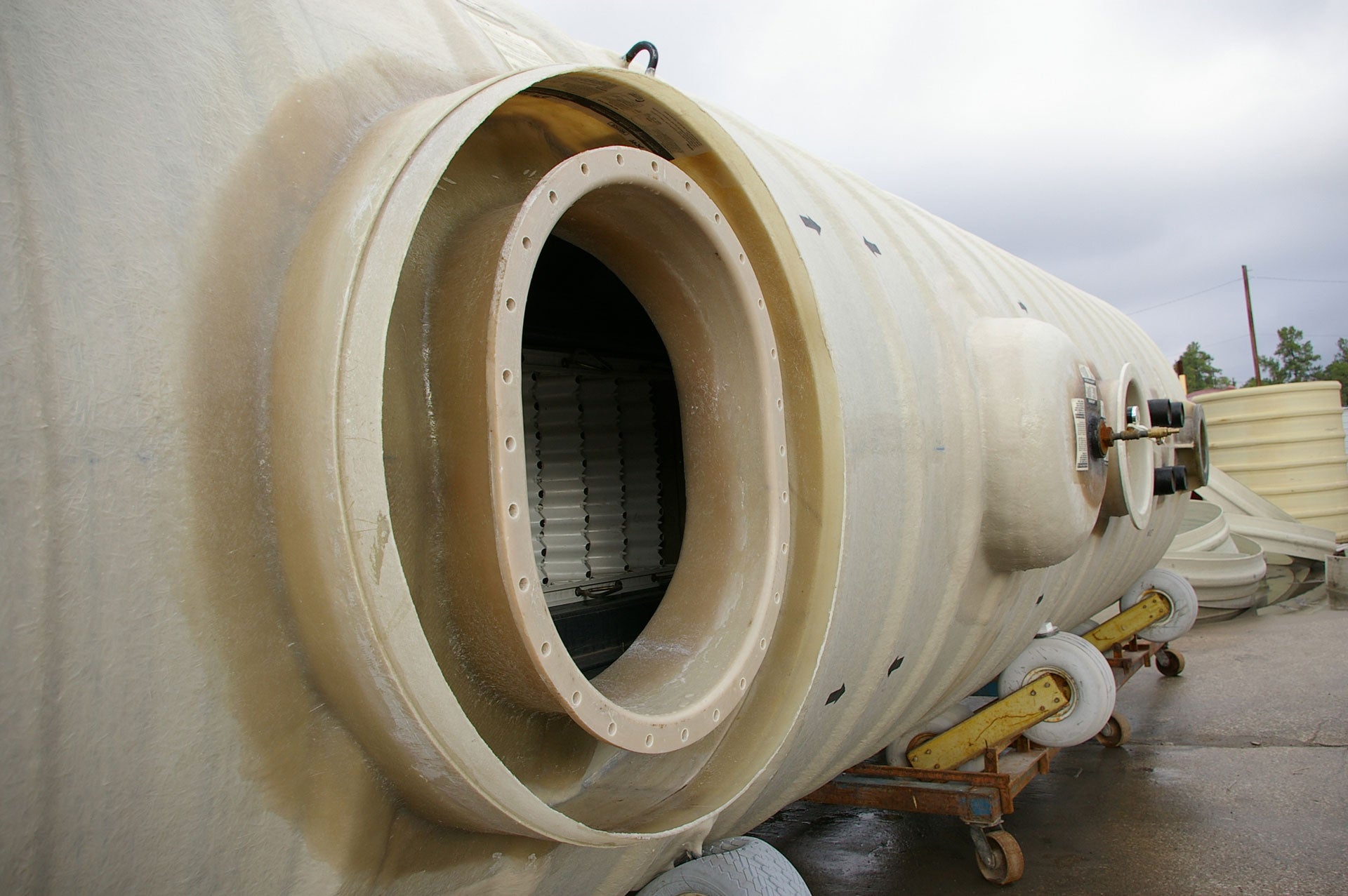 Fiberglass tank on cart at the facotory with the lid off showing the filter packs inside. 