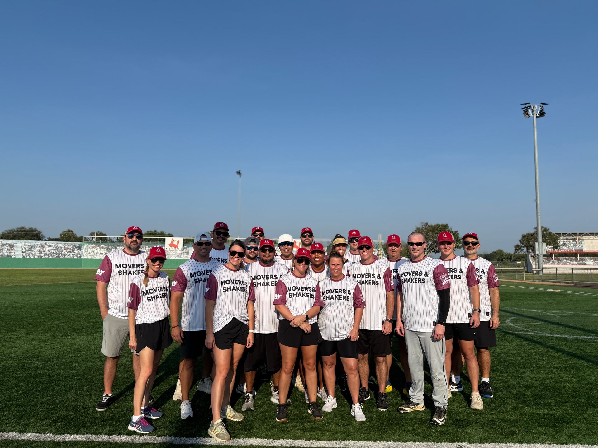 Movers & Shakers team posed on the field at Derricks and Diamonds softball charity tournament