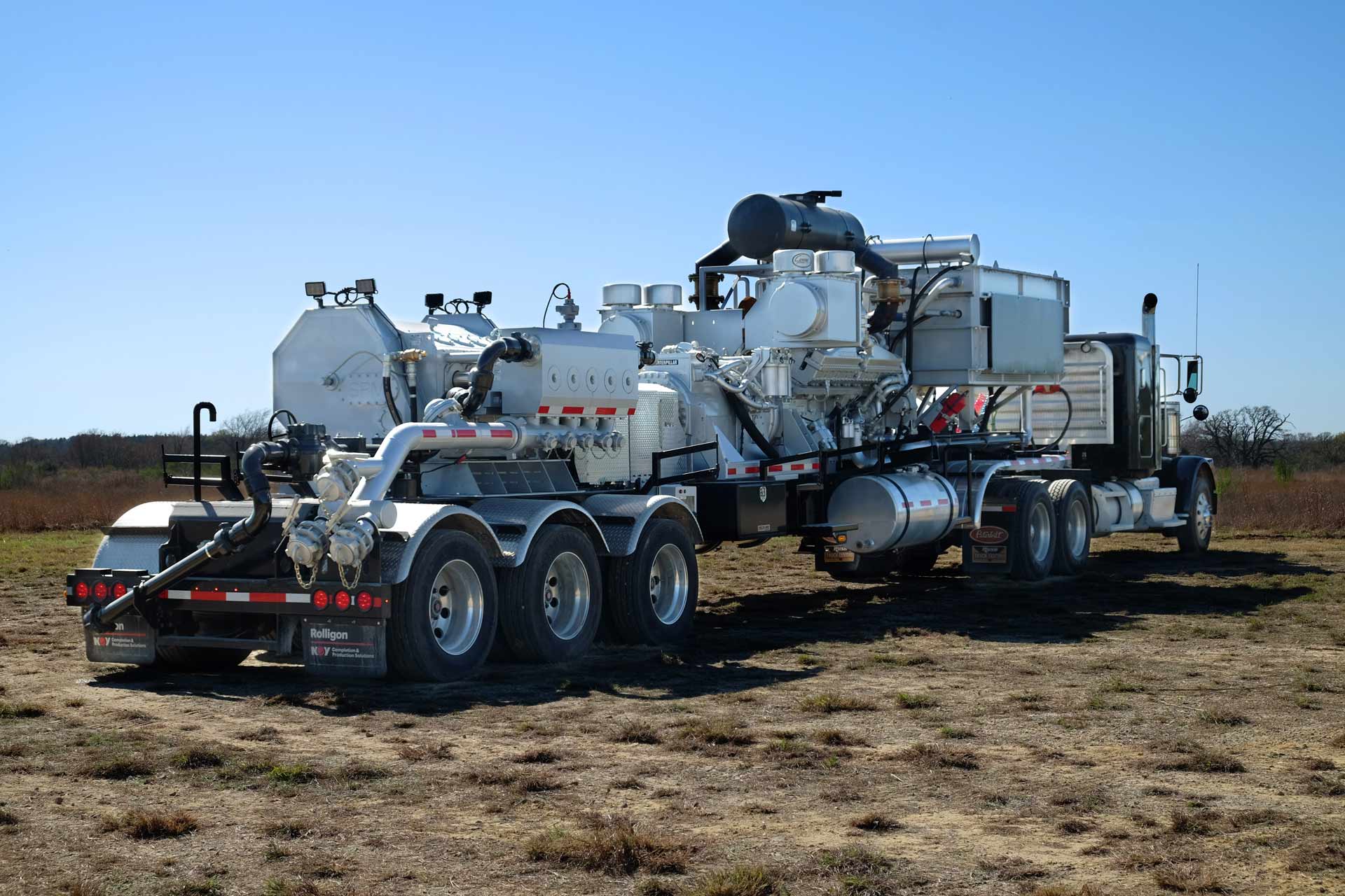 Rear/side view of Trailer-Mounted Frac pumper in field