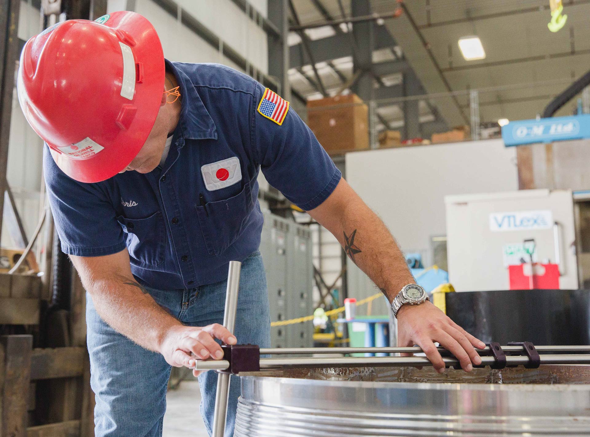 An in-house engineering measuring a product for XL Systems Service and Engineering