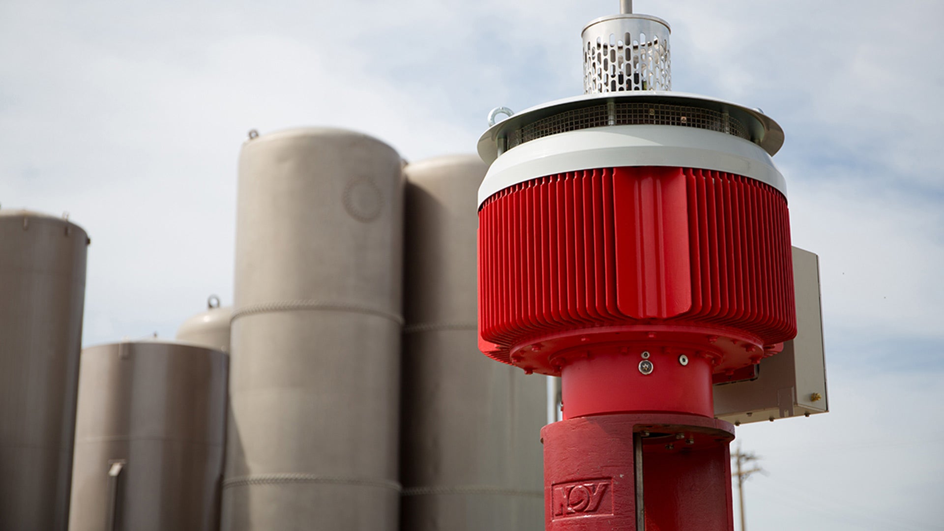 A Permanent Magnetic Motor (PMM) featured before a series of silos