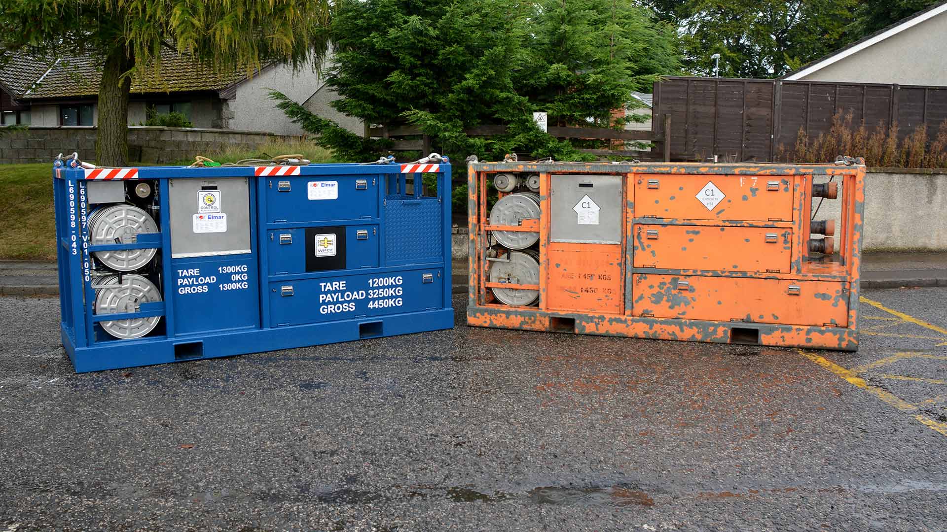 A recertified piece of equipment sits next to a piece in poor condition in a parking lot