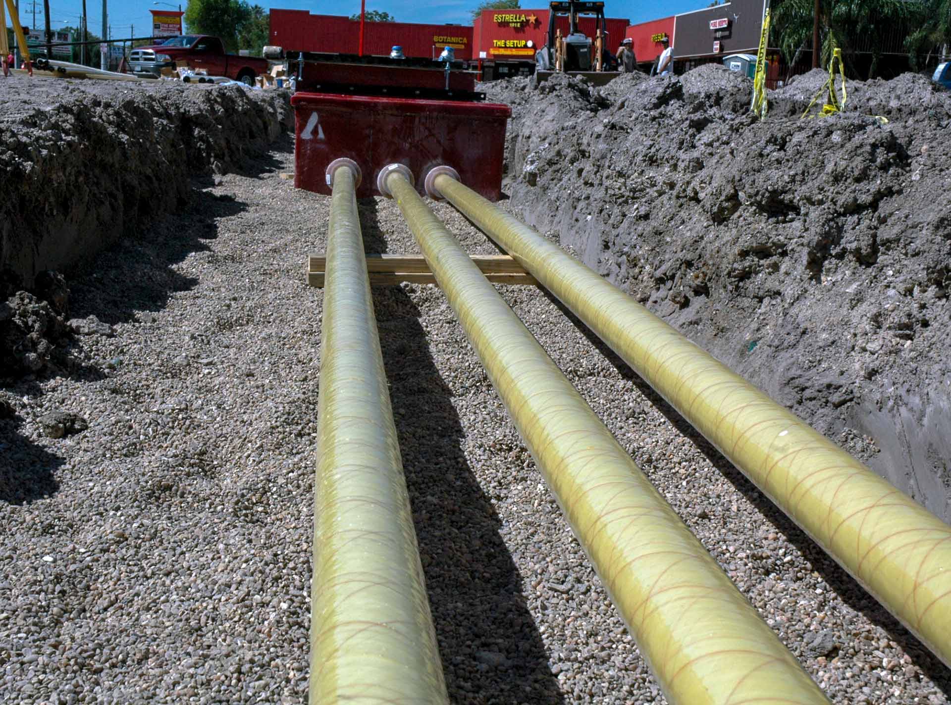 Low angle of Red Thread IIA Fiberglass Pipe in a ditch
