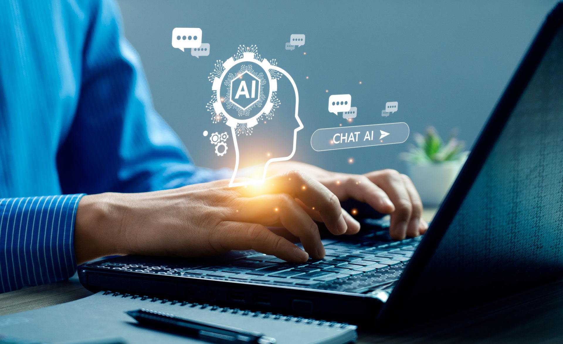 Image of hands typing on a laptop with AI related graphics overlaid