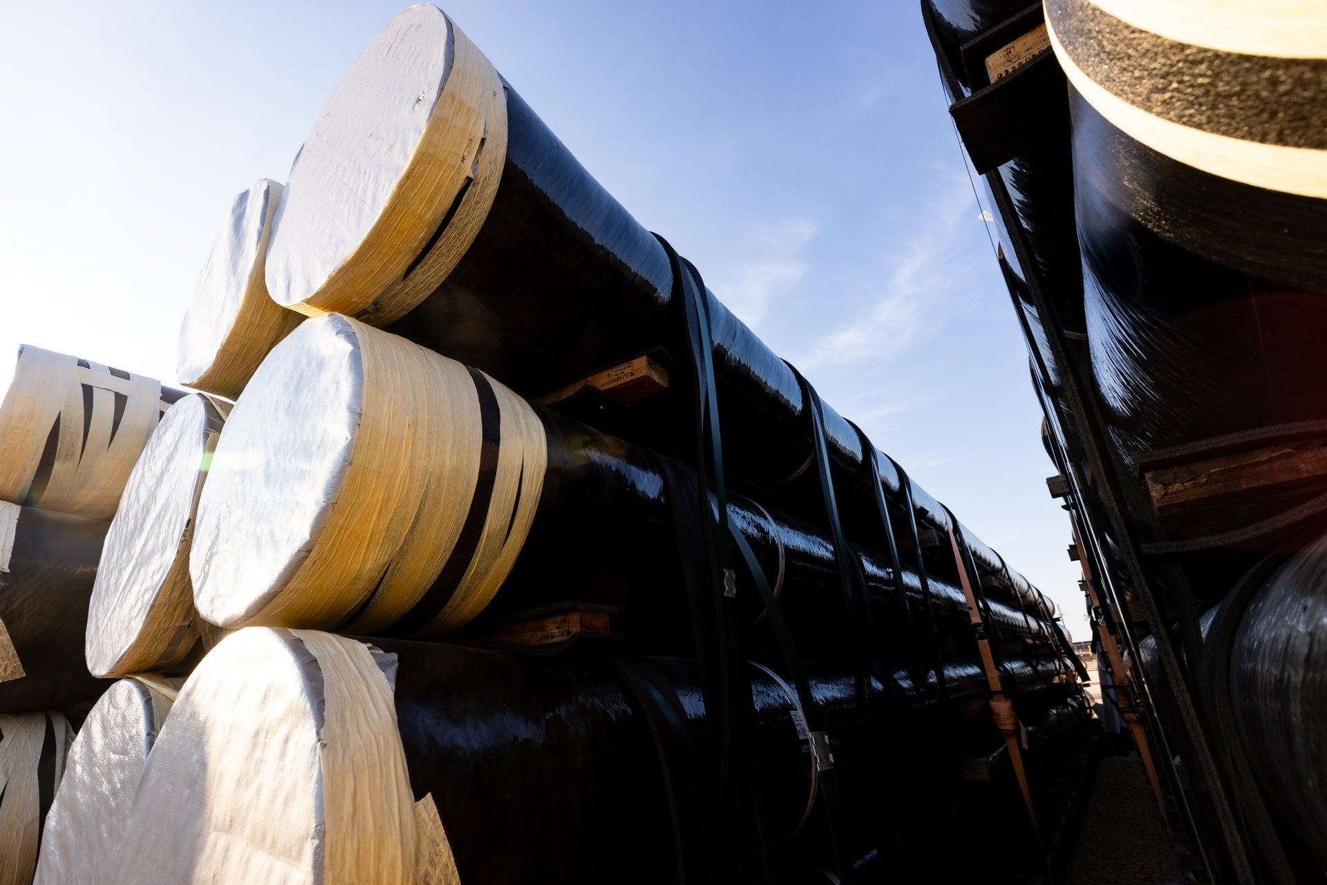 Fiberglass pipe stacked in yard