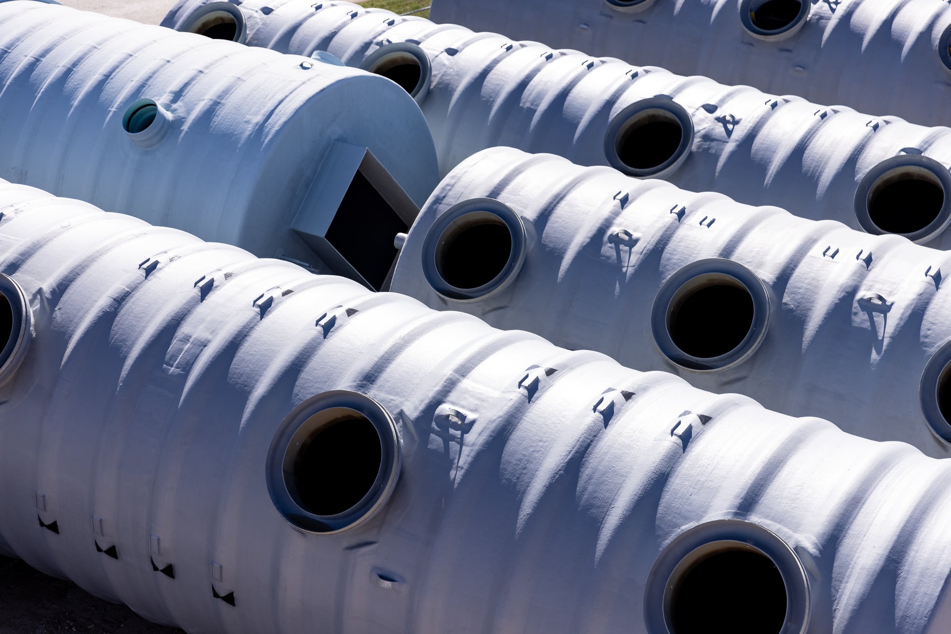 Rows of water tanks on the ground