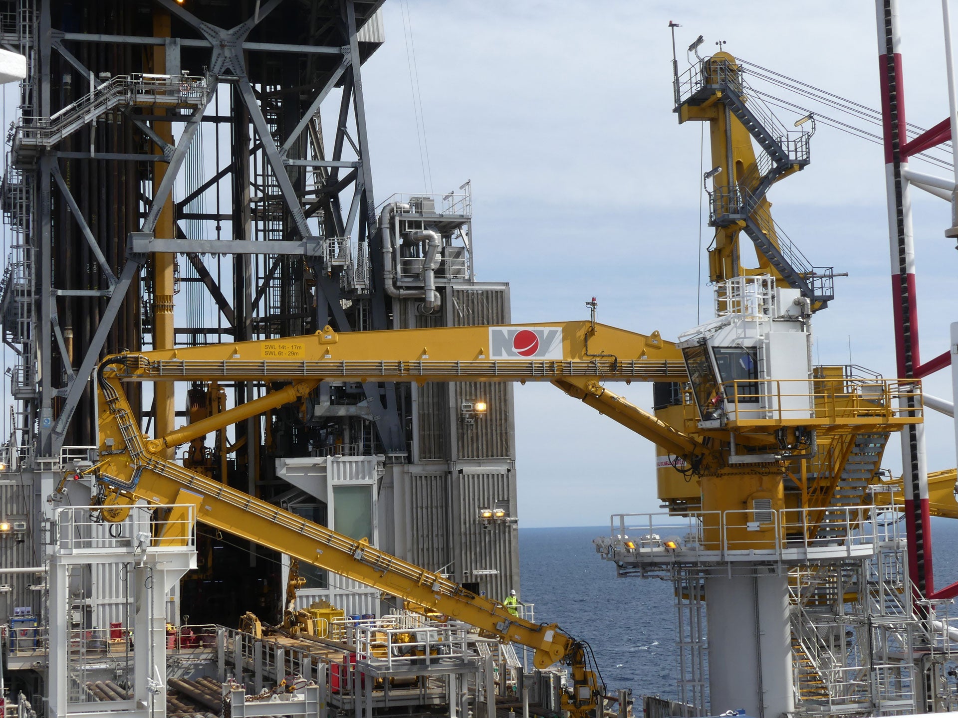 Equinor Askespott Drilling Platform offshore, with a yellow NOV-branded heavy lift crane on the forefront