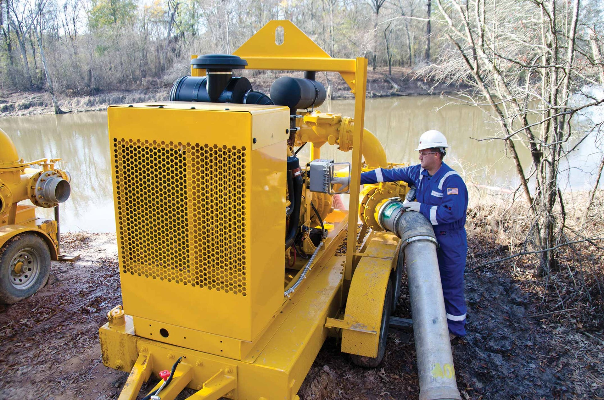 A technician manages water transfer equipment onsite