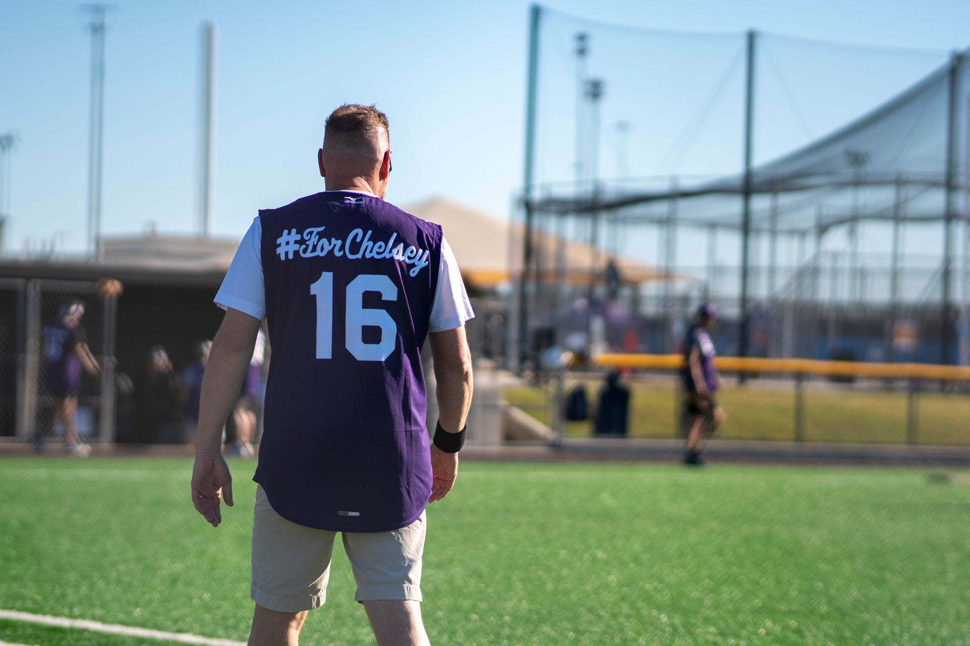 Outfielder wearing a purple jersey with the number 16 displayed - on the field of the Derricks and Diamonds tournament