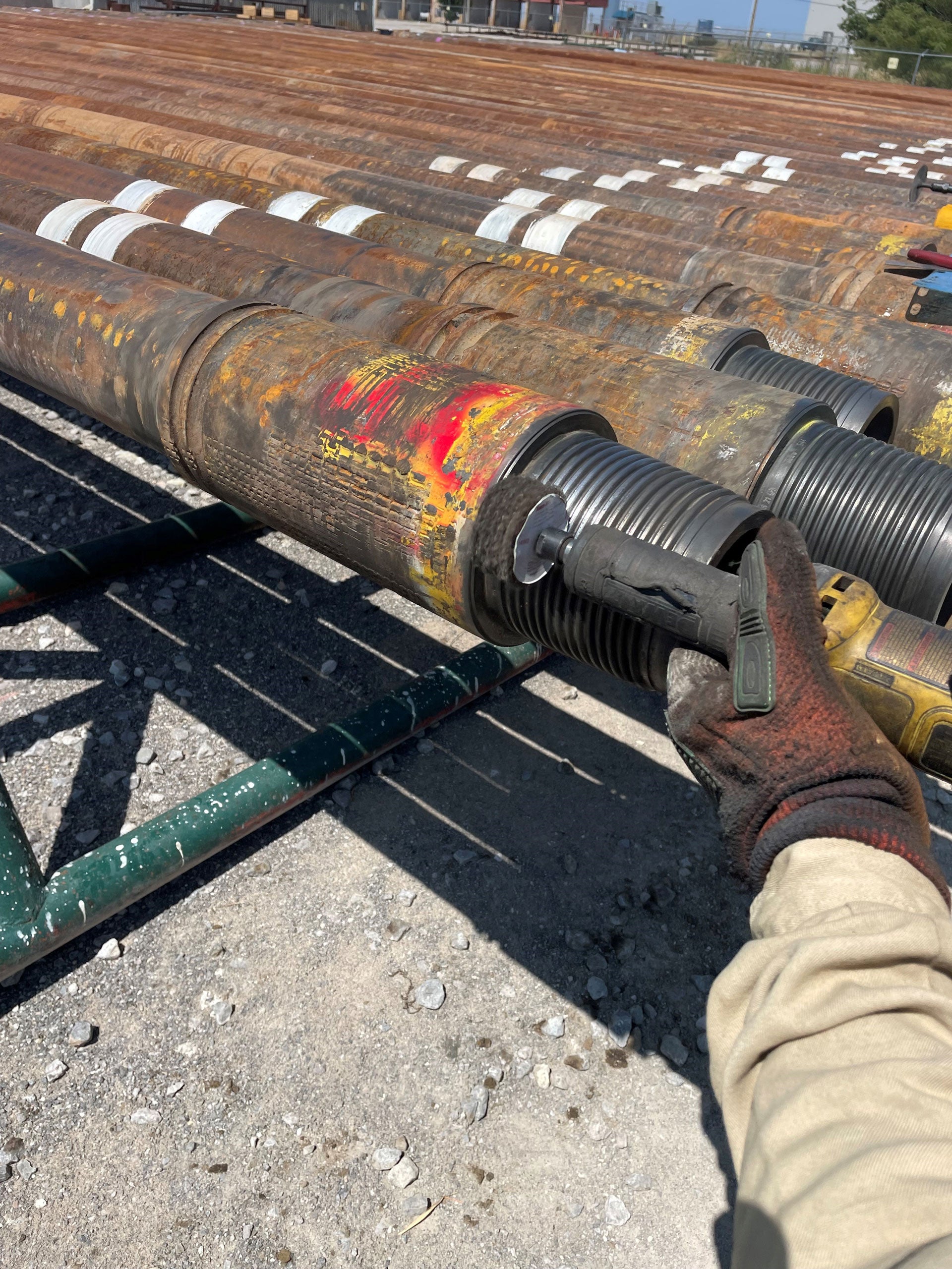 Close up of a technician's gloved hand buffing a connection